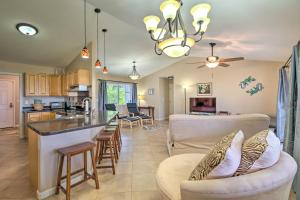 a kitchen and living room with a couch and a table at Hilo Oasis - 32 Mi to Volcanoes National Park! in Hilo
