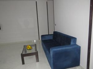 a blue couch and a coffee table in a room at Apartment Sorrento near the sea RedSeaLine in Hurghada