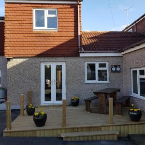 a wooden deck in front of a house at Chynoweth Court in Newquay