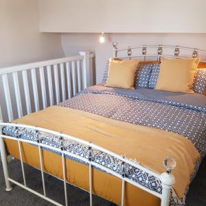 a bed with a metal bed frame in a room at Chynoweth Court in Newquay