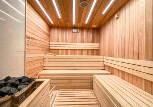 a sauna with wood paneled walls and a wooden floor at Perelik Hotel in Pamporovo