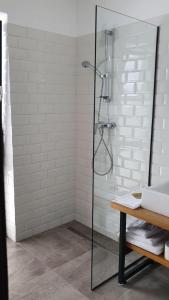 a shower with a glass door in a bathroom at The Pines Boutique Villa in Braşov