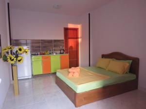 a bedroom with a bed and a kitchen with a refrigerator at Apartment Verona near the sea RedSeaLine in Hurghada