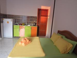 a room with a bed and a kitchen with a refrigerator at Apartment Verona near the sea RedSeaLine in Hurghada