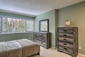 a bedroom with a bed and a mirror and a dresser at Cozy Condo Steps to Lake Michigan, 5 Mi to Boyne! in Harbor Springs