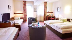 Postel nebo postele na pokoji v ubytování Hotel Merian Rothenburg