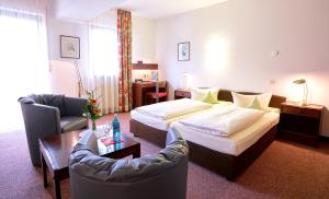 Postel nebo postele na pokoji v ubytování Hotel Merian Rothenburg