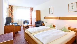 Postel nebo postele na pokoji v ubytování Hotel Merian Rothenburg