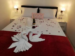 a bed with two swans made to look like roses at The Maltese Sun in Sliema