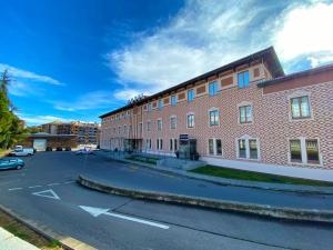 an empty street in front of a brick building at Hotel Berga Park in Berga