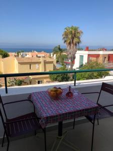 a table with a bowl of fruit on a balcony at Debimar Apartamentos in Albufeira