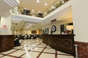 a hotel lobby with a waiting area and a clock at Asal Hotel in Ankara