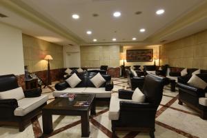 a lobby with couches and chairs and a table at Asal Hotel in Ankara