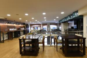 a restaurant with two tables and chairs and a bar at Asal Hotel in Ankara