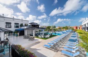 an outdoor patio with lounge chairs and a pool at Inn On Fifth in Naples