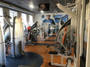 a man in a gym with several tread machines at Hotel Sabina in Riga