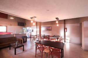 a restaurant with tables and chairs in a room at El Ciervo in Sierra Nevada