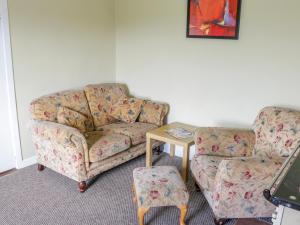 a living room with a couch and a table at Glor Cottage in Ballyhaunis