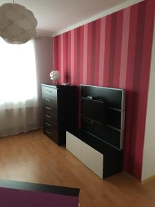 a living room with a tv and a dresser at Apartmán Edita in Velké Losiny