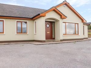 a house with a driveway in front of it at Rossanean in Farranfore