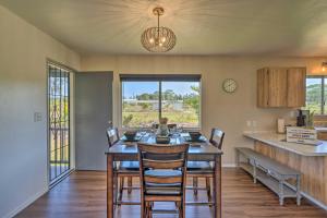 a kitchen and dining room with a table and chairs at Keaau Home - 34 Mi to Volcanoes NP, Near Hilo in Keaau