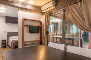 a room with a table and a bed and a window at Camping Village Santapomata in Castiglione della Pescaia