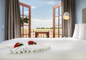 a bedroom with a white bed with flowers on it at Apartamento Familiar Vacaciones en Curacao in Jan Thiel