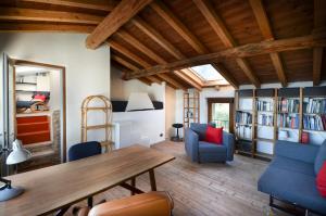 a living room with a wooden table and blue chairs at Casa Gaino in Toscolano Maderno