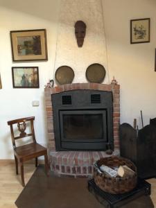 a living room with a brick fireplace with pots and pans at Ampio e luminoso appartamento a 2 passi da Pavia in Cava Manara