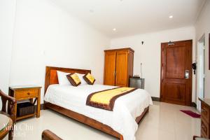 Säng eller sängar i ett rum på Ninh Chu Hotel