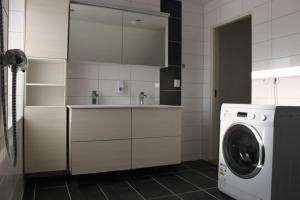 uma cozinha com uma máquina de lavar roupa e uma máquina de lavar roupa em Lagunen Apartments em Bergen