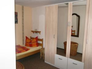 ヘリングスドルフにあるBungalow Heinzeのベッドルーム1室(ベッド1台付)、クローゼット(鏡付)