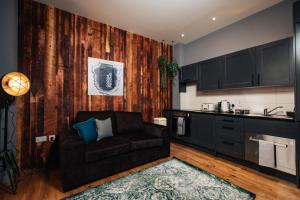 a living room with a couch and a kitchen at BrewDog Kennels - Aberdeen in Aberdeen