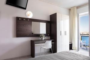 Televízia a/alebo spoločenská miestnosť v ubytovaní Hotel Stacchini