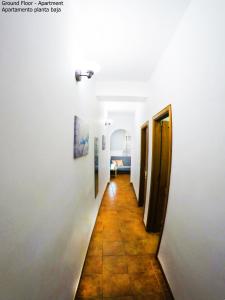 a hallway with white walls and a tile floor at Apartamentos Ester in Santa Cruz de Tenerife
