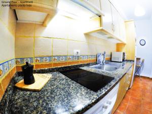 a kitchen with a sink and a counter top at Apartamentos Ester in Santa Cruz de Tenerife