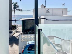 a balcony with a car parked on a building at Canaryislandshost l Brisa del Atlántico in Playa Honda