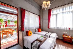 a bedroom with two beds and a table and a dining room at Farmland B&B in Guilin