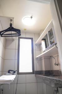 a bathroom with two sinks and a window in it at Soft Win Hotel São Luís in São Luís