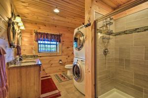 a bathroom with a shower and a washing machine at Trenton Cabin with Hot Tub - 14 Mi to Lookout Mtn! in Trenton +27 photos