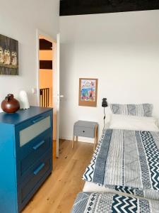 a bedroom with a blue dresser and a bed at Ferienwohnung Mountainlook in Hohegeiß