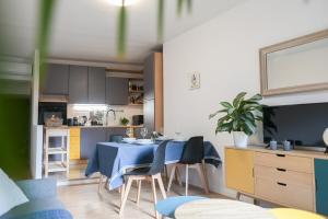 a kitchen with a blue table and chairs in a room at Un terrazzo sulla magia in Siena