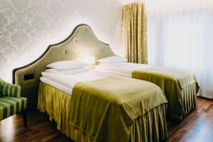 Postel nebo postele na pokoji v ubytování Hotel Bristol