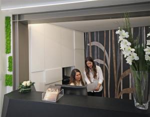 two women standing in front of a mirror at Hotel Continental & Residence in Gabicce Mare