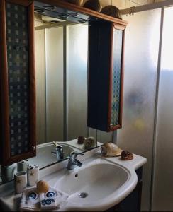 a bathroom with a sink and a mirror at Casa Del Mare (South Evia) in Nea Stira