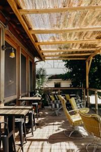 a patio with tables and chairs and a wooden pergola at Drake Devonshire in Wellington