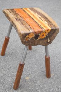 a wooden stool sitting on top of a table at Apartmani Papeš in Krapina