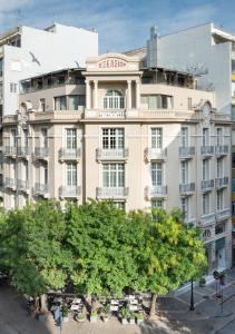 a large building with a tree in front of it at The Excelsior Small Luxury Hotels of the World in Thessaloniki