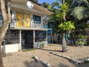 a building with a surfboard in front of it at Uvita Pirates Hostel in Uvita