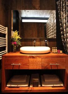 a bathroom with a sink and a large mirror at Hotel Punta Sirena in Curanipe